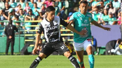Jugadores del León y Necaxa disputan el balón en partido de la Liga MX