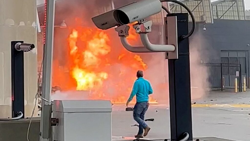 Un hombre mira el fuego provocado por una explosión en la frontera entre Estados Unidos y Canadá