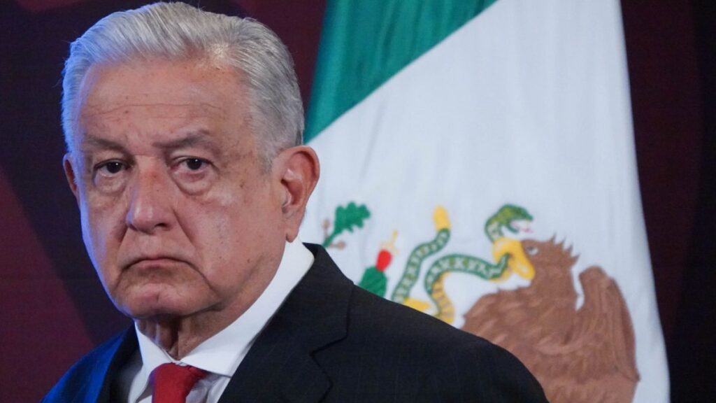 Presidente Andrés Manuel López Obrador con bandera de México de fondo