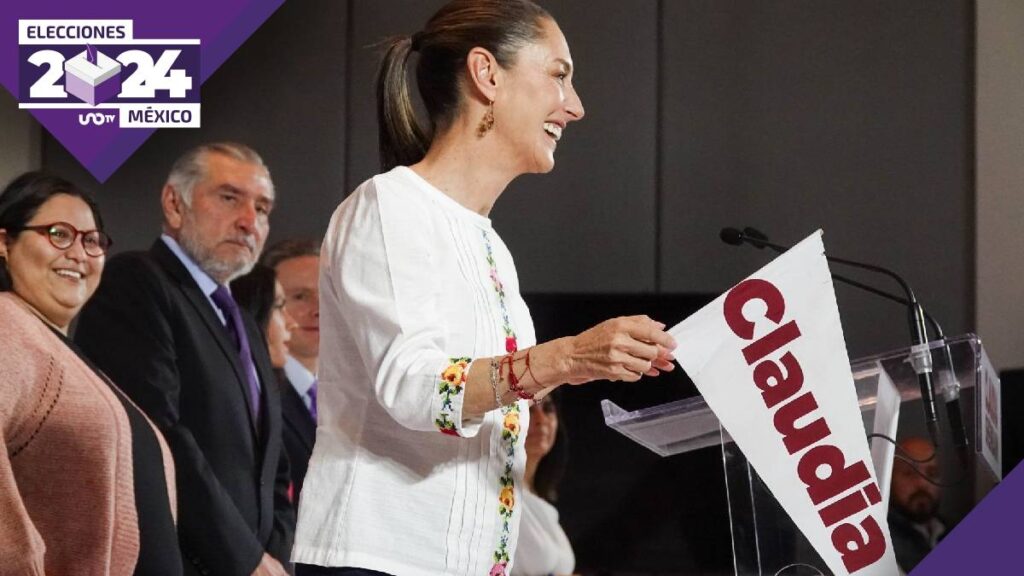 Claudia Sheinbaum con un banderín en la mano en un evento de campaña